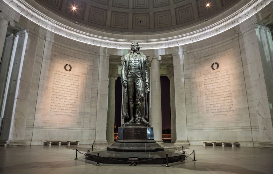 A statue of Thomas Jefferson in a grand hall with marble walls and columns. 4