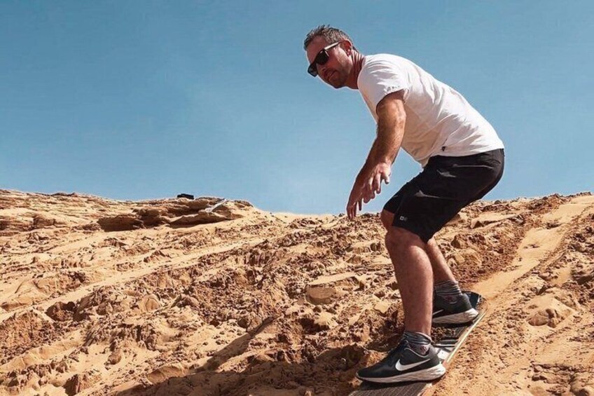 A person climbing a sandy slope. 3