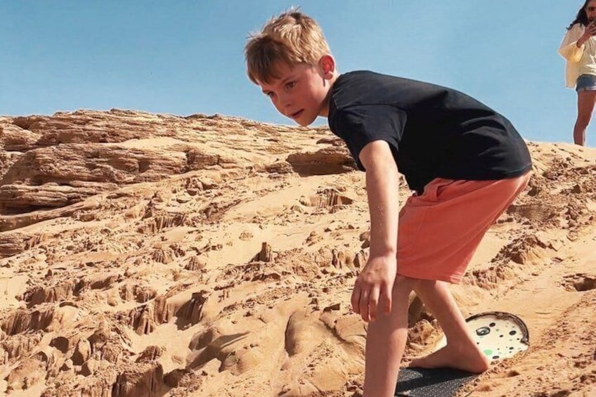 A person playing with sand on a beach. 4