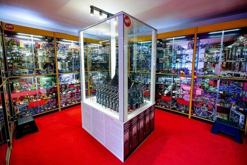 A glass display case with various toys and collectibles. 2