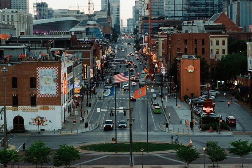 A busy urban street with cars, pedestrians, and buildings. 3