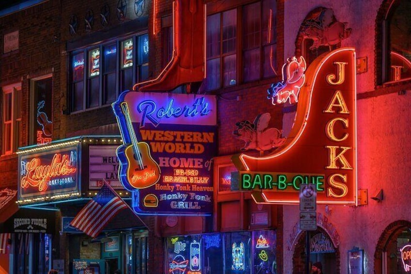 Neon signs for 'Robert's Western World Home of Bratwurst' and 'JACKS Bar-B-Q'. 1