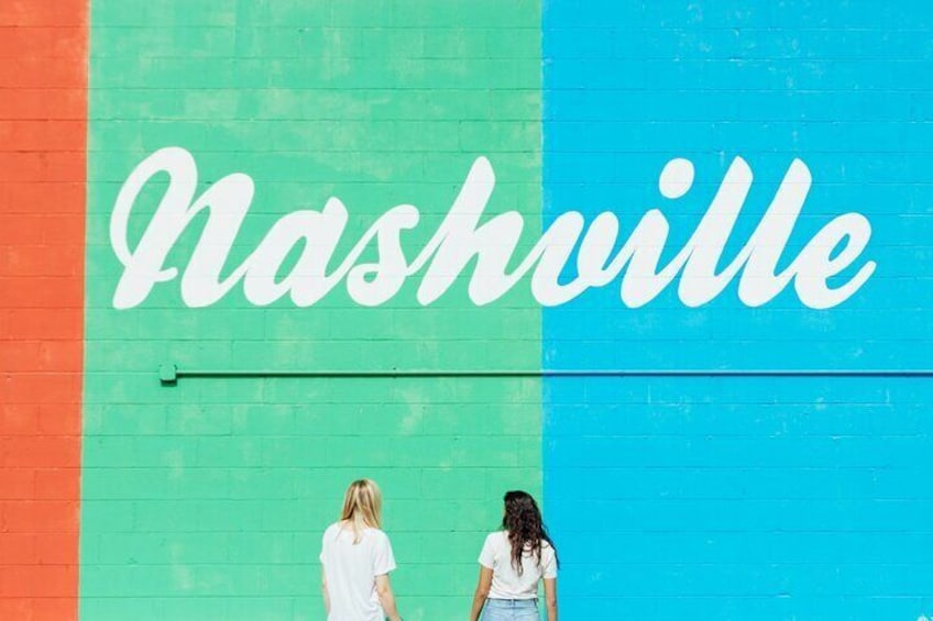 A mural with the word "Nashville" in white letters on a green and blue background. 4