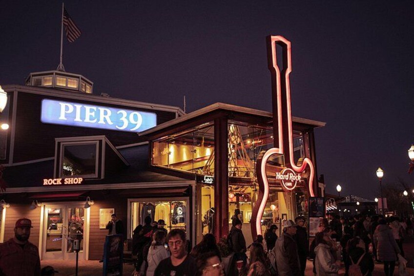 Pier 39 with a neon guitar sign, Rock Shop, and Hard Rock Cafe. 1