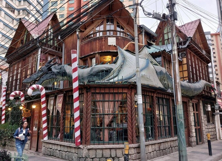 A building with a wooden facade, candy cane decorations, and a large dragon sculpture. 3