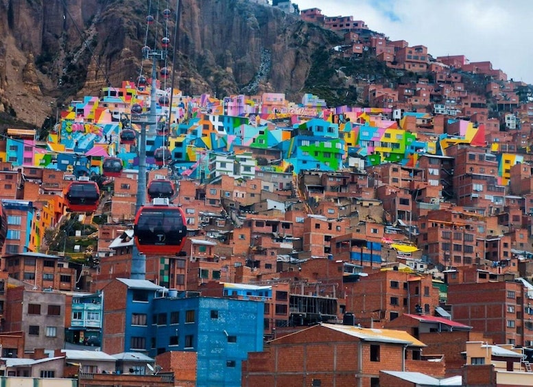 A densely packed hillside with colorful buildings and a cable car system. 5
