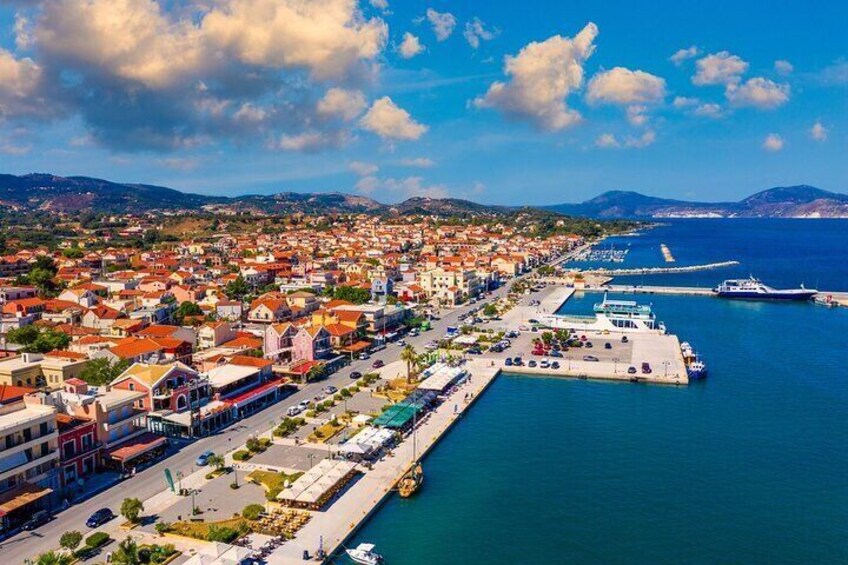 A coastal town with a marina, waterfront promenade, and residential buildings. 5