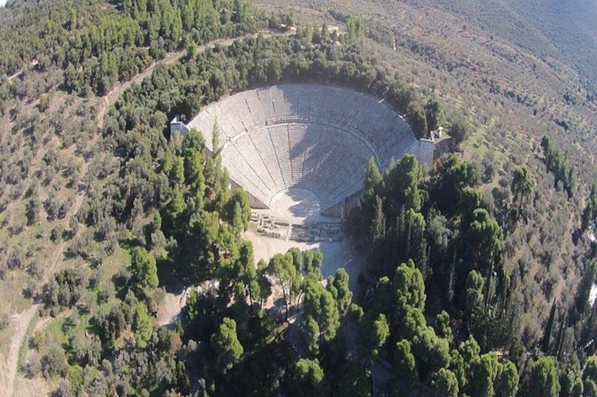 A large amphitheater surrounded by dense forest. 1