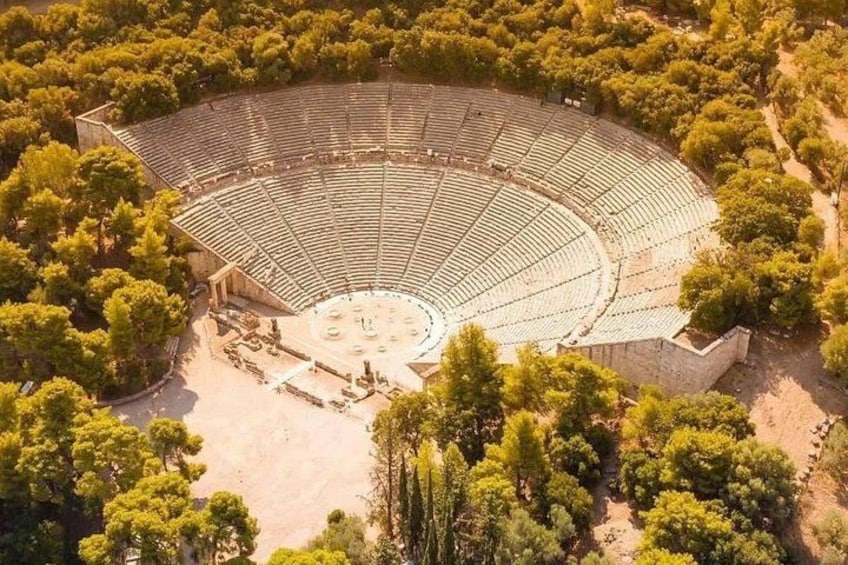 An ancient amphitheater surrounded by dense trees. 2
