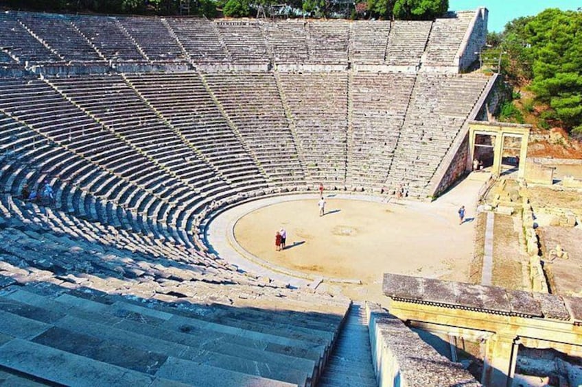 An ancient amphitheater with tiered seating and a central stage. 3