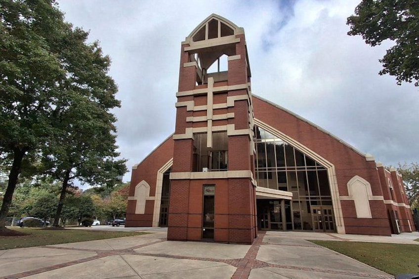 A church with a prominent steeple and large windows. 4