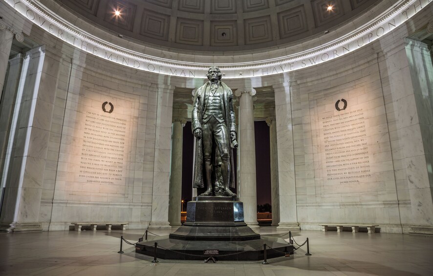 A statue of Thomas Jefferson in a grand hall with marble walls and columns. 4