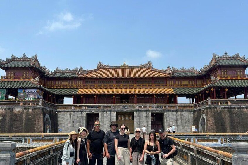 A traditional Chinese building with ornate architecture, a stone bridge, and a clear sky. 4