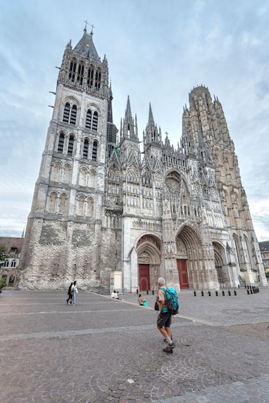 A historic cathedral with intricate Gothic architecture, including flying buttresses and a large rose window. 4