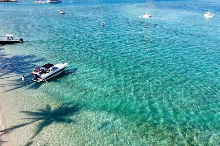 Join the vibrant Peanut Island sandbar scene with calm water ideal for swimming and lounging. 2