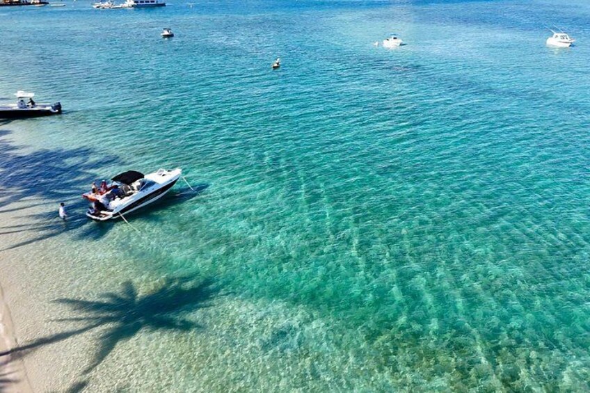 Join the vibrant Peanut Island sandbar scene with calm water ideal for swimming and lounging. 4