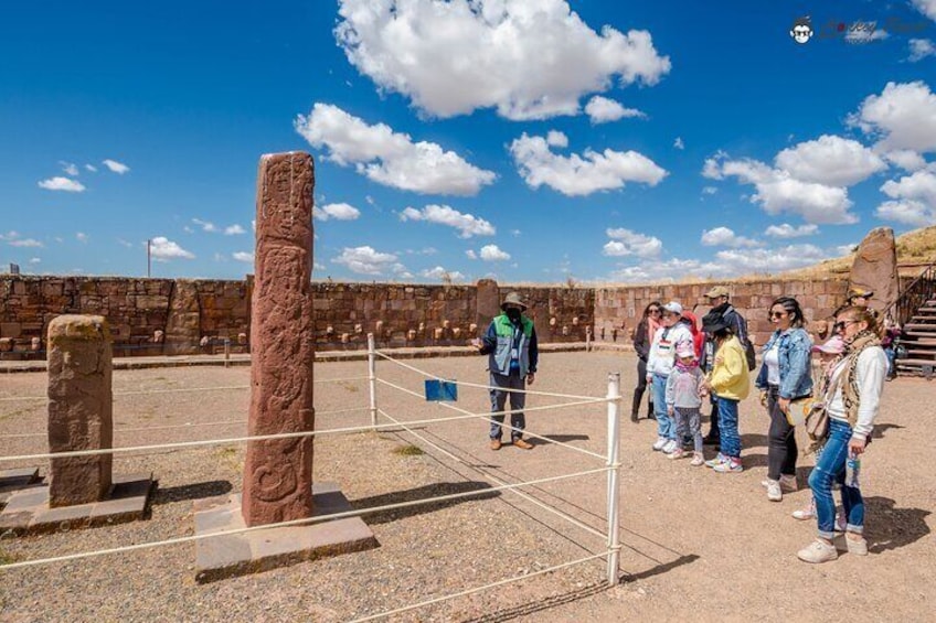 Ancient stone columns and a stone wall in a historical site. 1