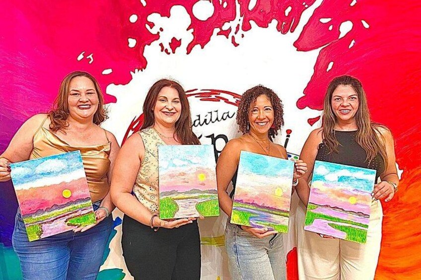 Four individuals holding paintings of landscapes. 1