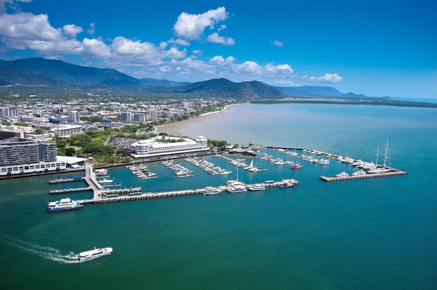 A coastal city with a marina, boats, and a beach. 2