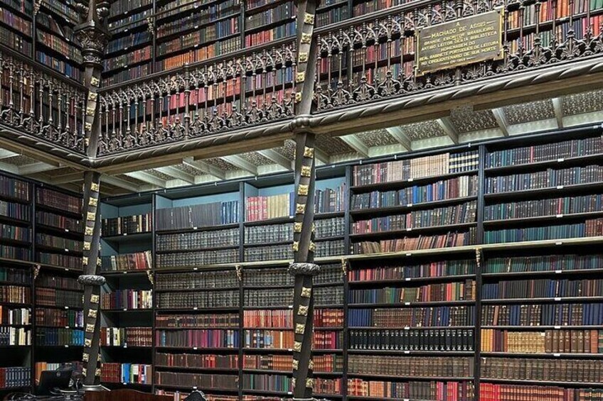A large, ornate library with multiple levels of bookshelves filled with books. 3