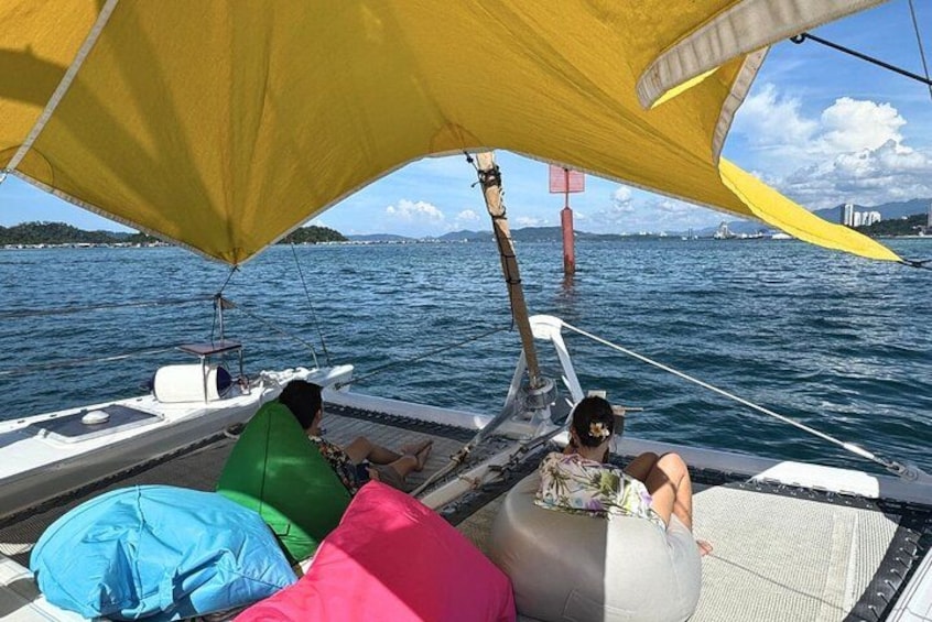 A boat with colorful cushions and a sail. 2