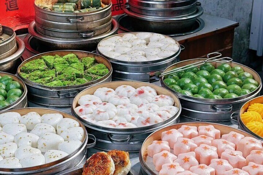 Verschillende traditionele Chinese desserts gepresenteerd in metalen bakjes. 3