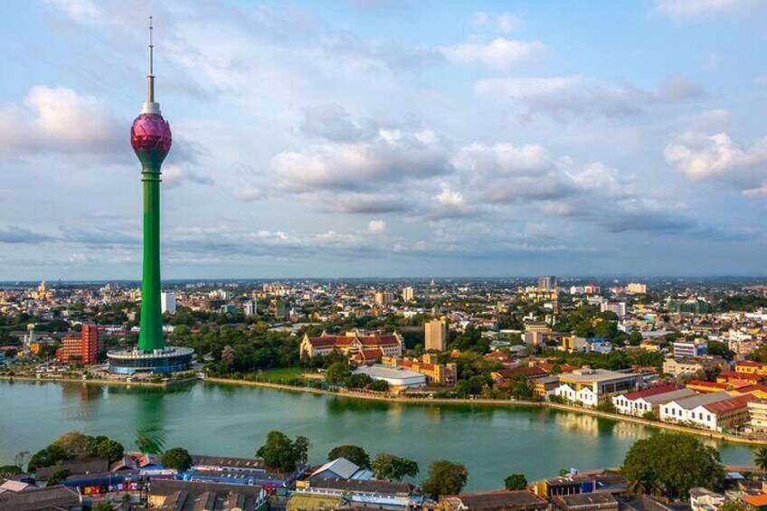 A cityscape with a prominent tower and a body of water. 5