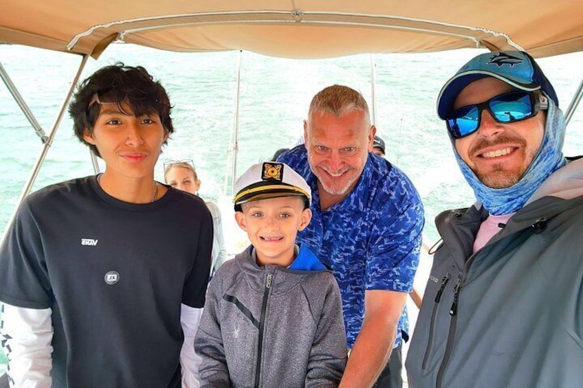 A group of people on a boat with a canopy overhead. 2