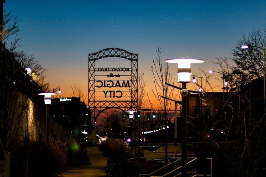 A city sign with 'CITY OF AMMANFORD' at dusk. 5