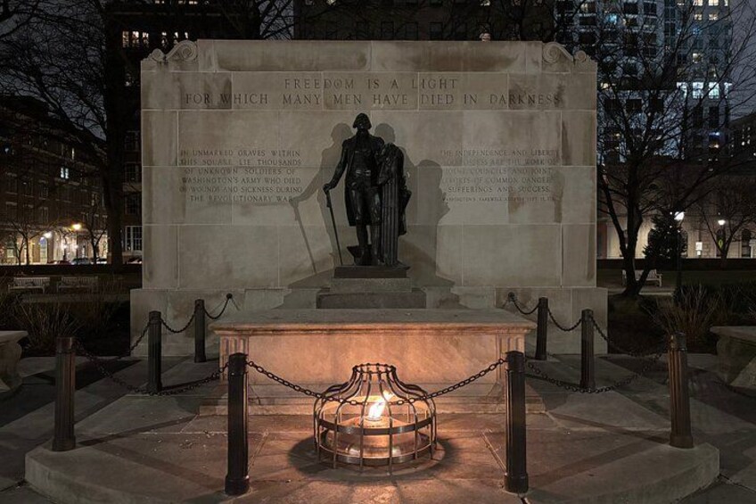 Een monument met een standbeeld, omringd door een hek en een kettingbarrière. 2