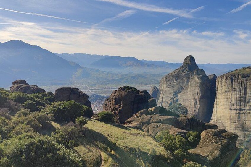 A view of the north side of Meteora from the viewdeck and at the fat back the first mountains of Pindos 5