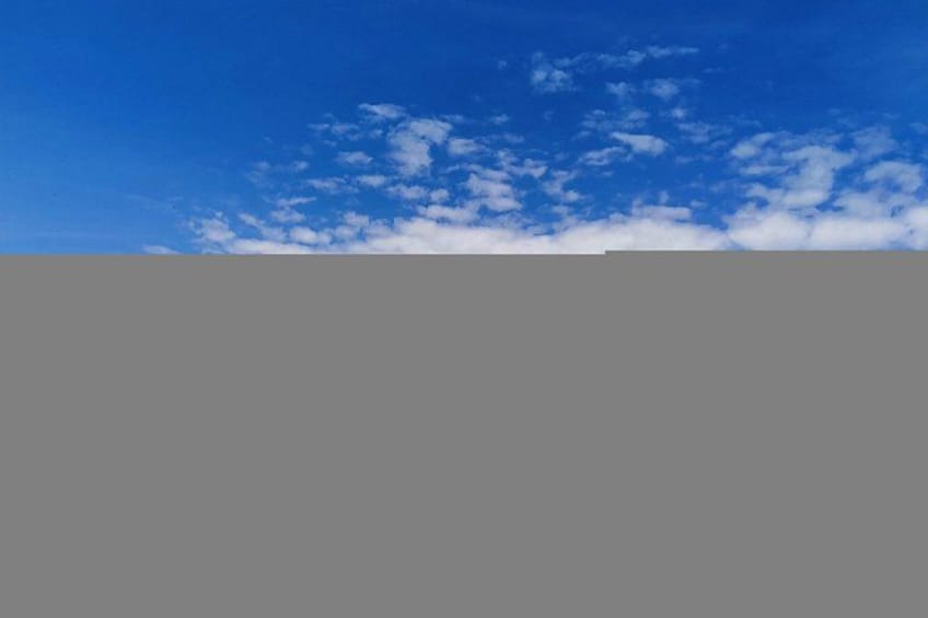 A clear blue sky with scattered clouds. 5