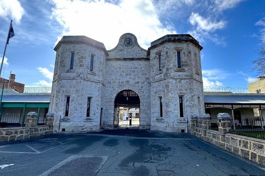 A historic stone building with a clock tower and arched entrance. 4