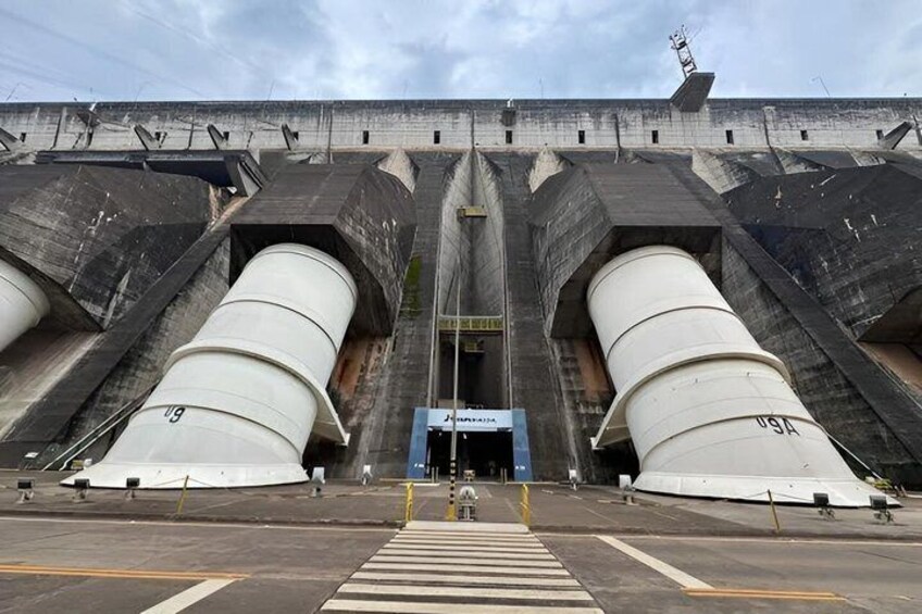 A large industrial structure with two large cylindrical tanks and a blue entrance. 3