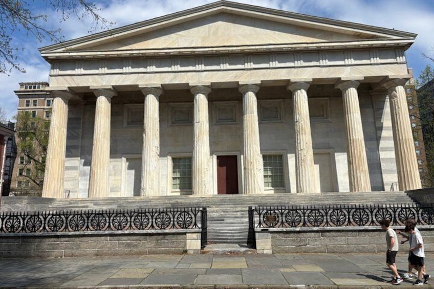 A neoclassical building with columns and a portico. 4