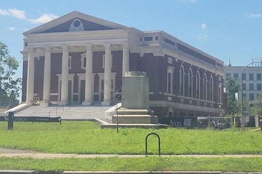 A large building with a classical architectural style, featuring columns and a symmetrical facade. 2