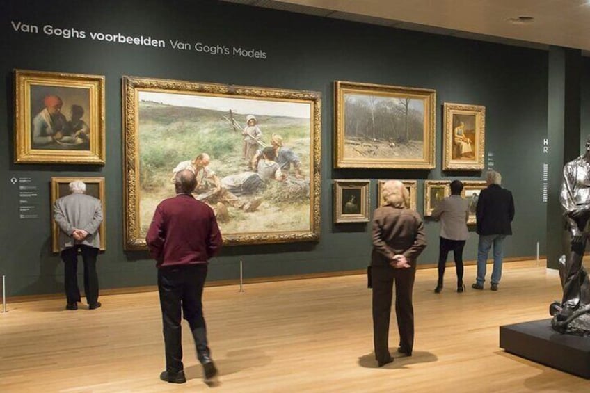An art gallery with several paintings on display. 2