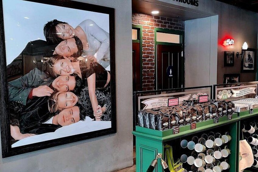A framed photo of a group of people, a brick wall, and a display of various items. 5