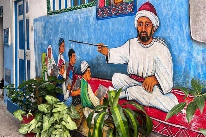 A mural of a man teaching children on a bench, surrounded by plants. 5