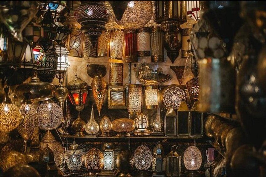 A variety of ornate metal lanterns and decorative items, likely in a market or shop setting. 3