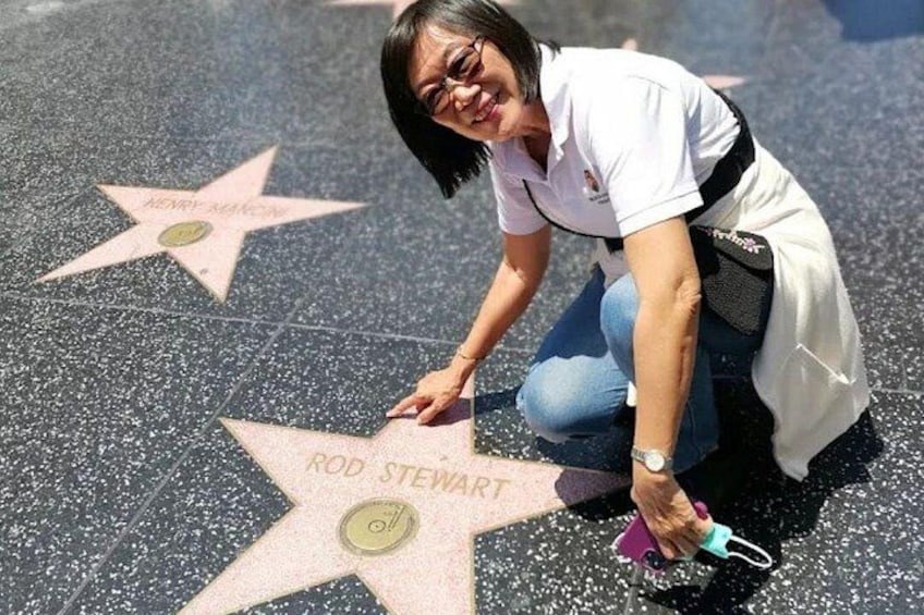 A person cleaning a Hollywood Walk of Fame star. 4