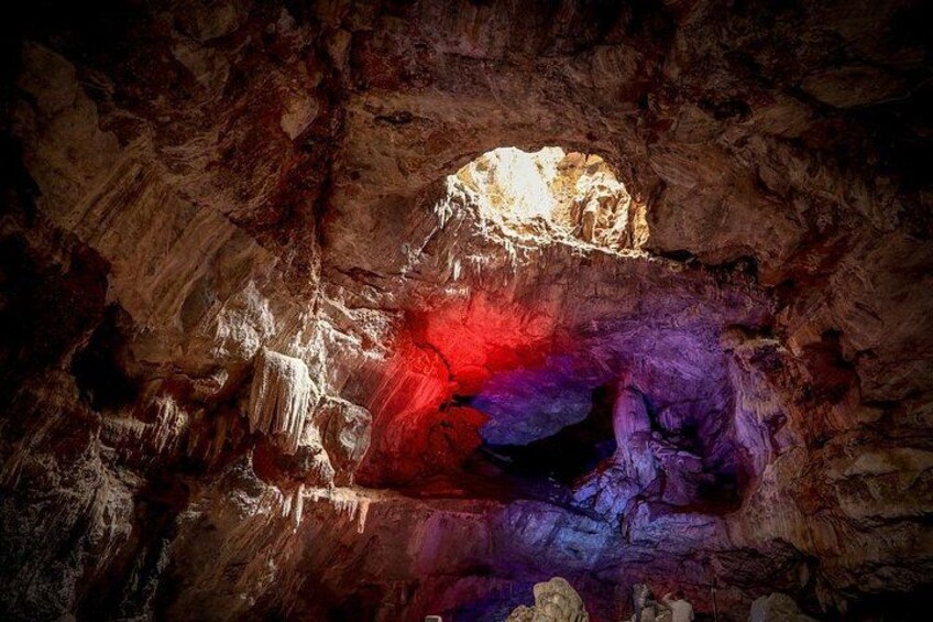 A cave with stalactites and a red glow. 2