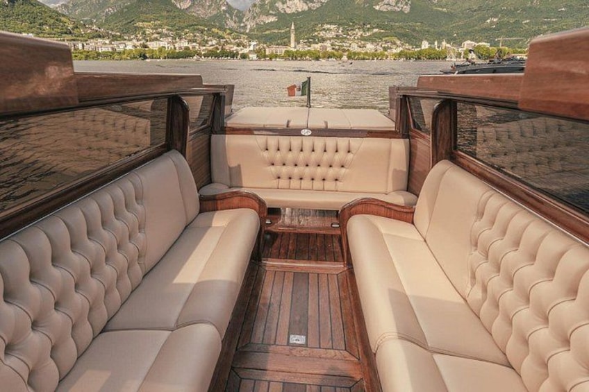 A boat interior with leather seating and a wooden deck. 4
