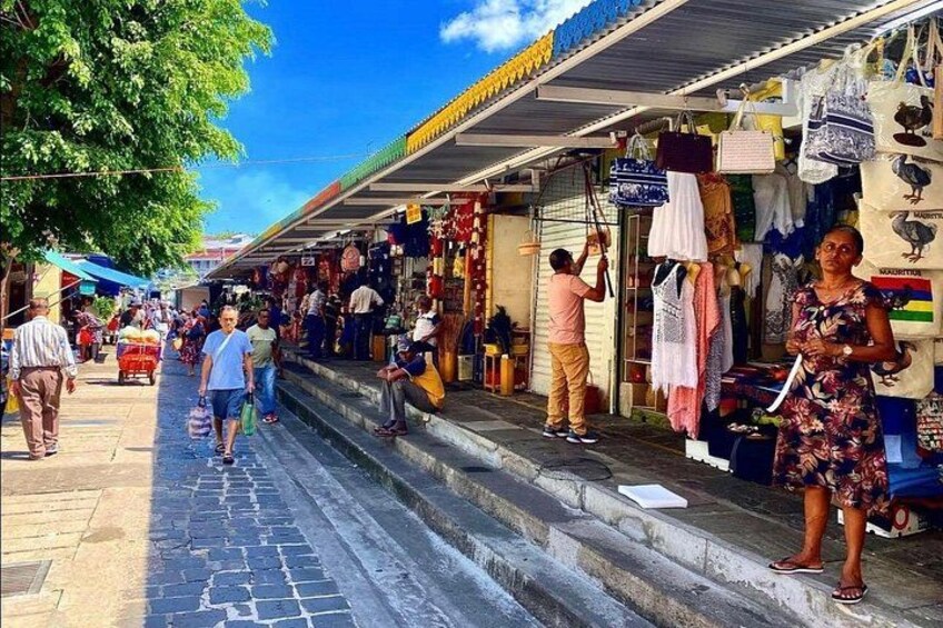 A bustling outdoor market with vendors and shoppers. 3