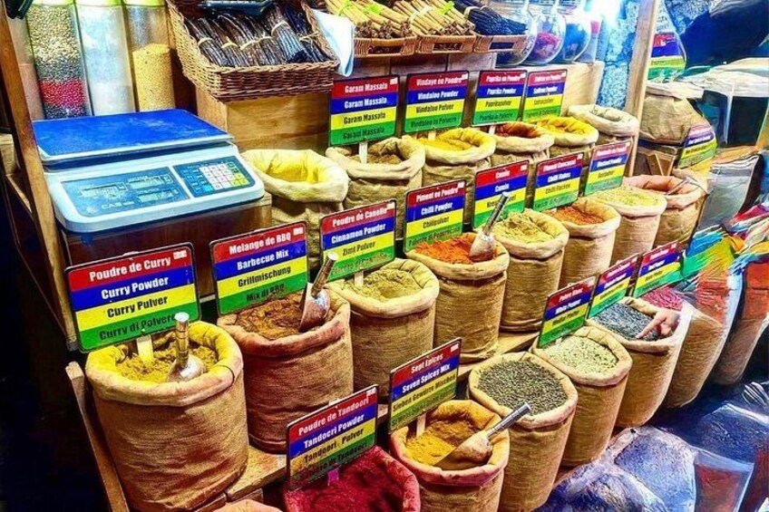 A spice market with labeled bags of various spices like curry powder and chili powder. 2