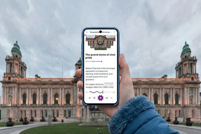 A person holding a smartphone displaying a webpage about Belfast City Hall. 1