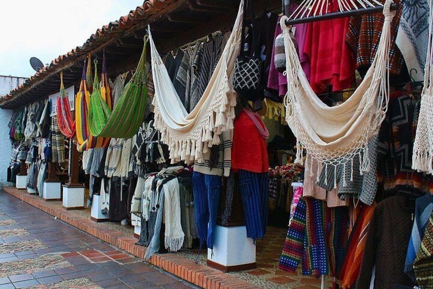A market stall with colorful hammocks and textiles. 3