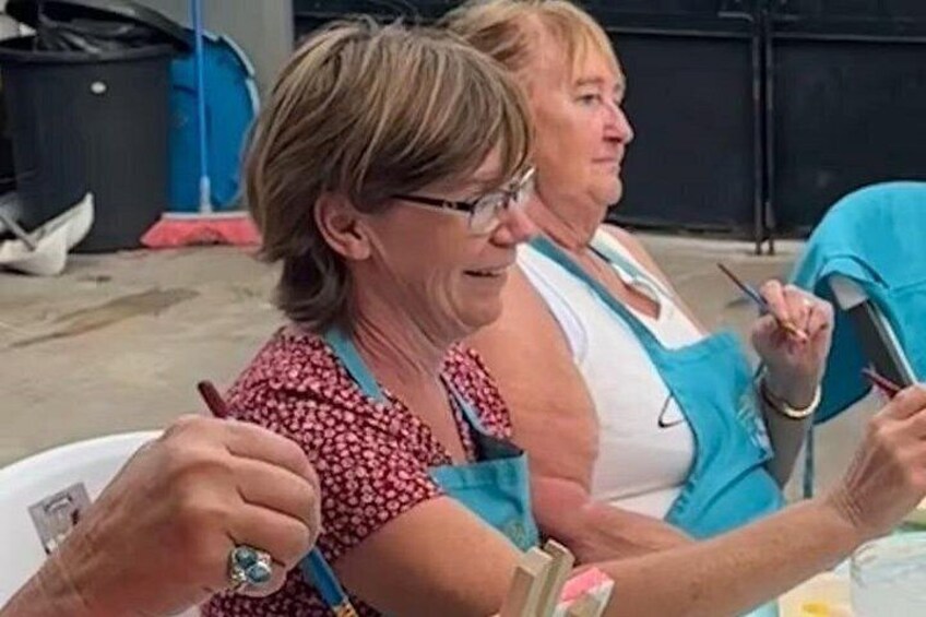 Two people sitting at a table, one holding a pen and the other holding a clipboard. 4