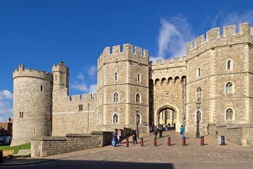 A historic stone castle with multiple towers and arched windows. 2