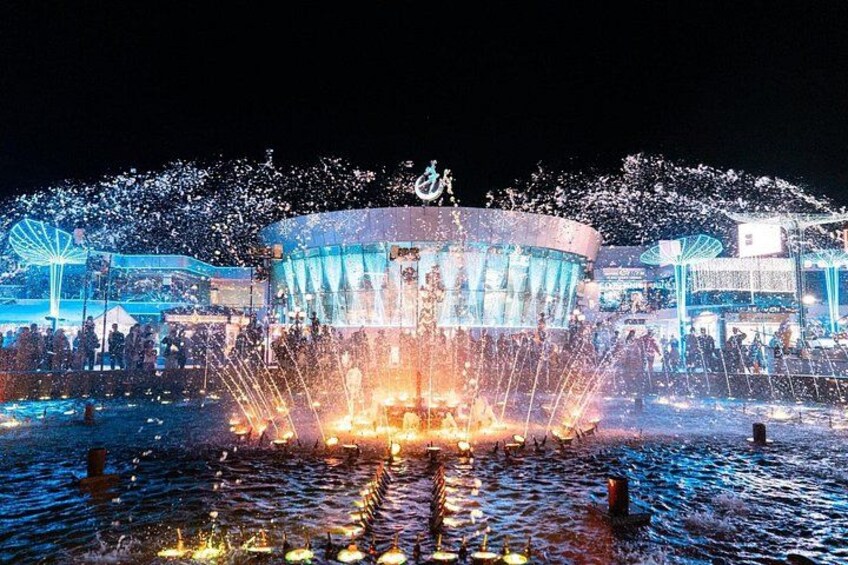 A water fountain with water jets and a building in the background. 2